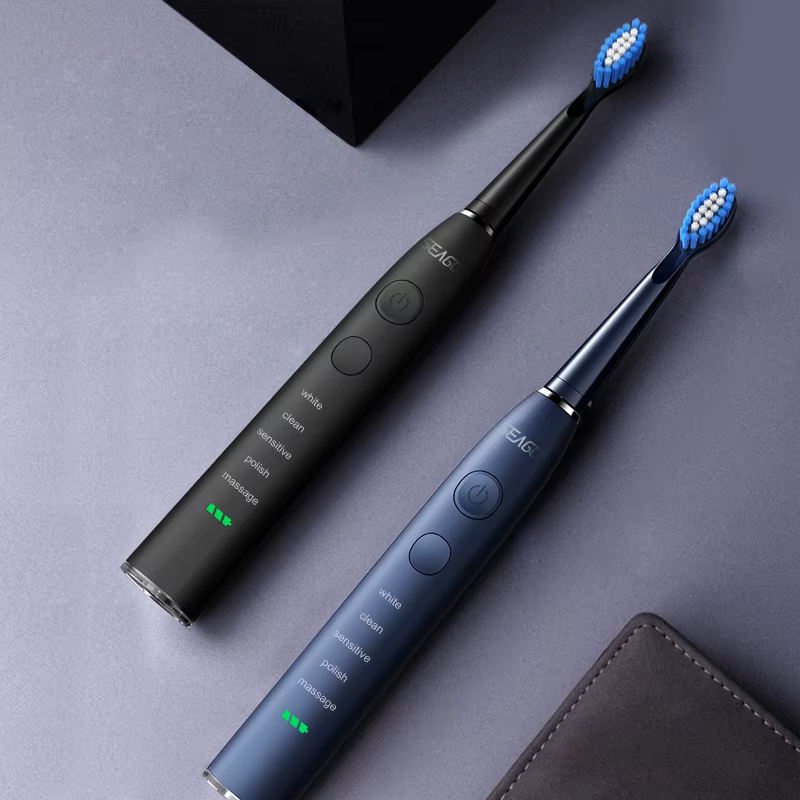 Two electric toothbrushes with blue bristles on a gray surface