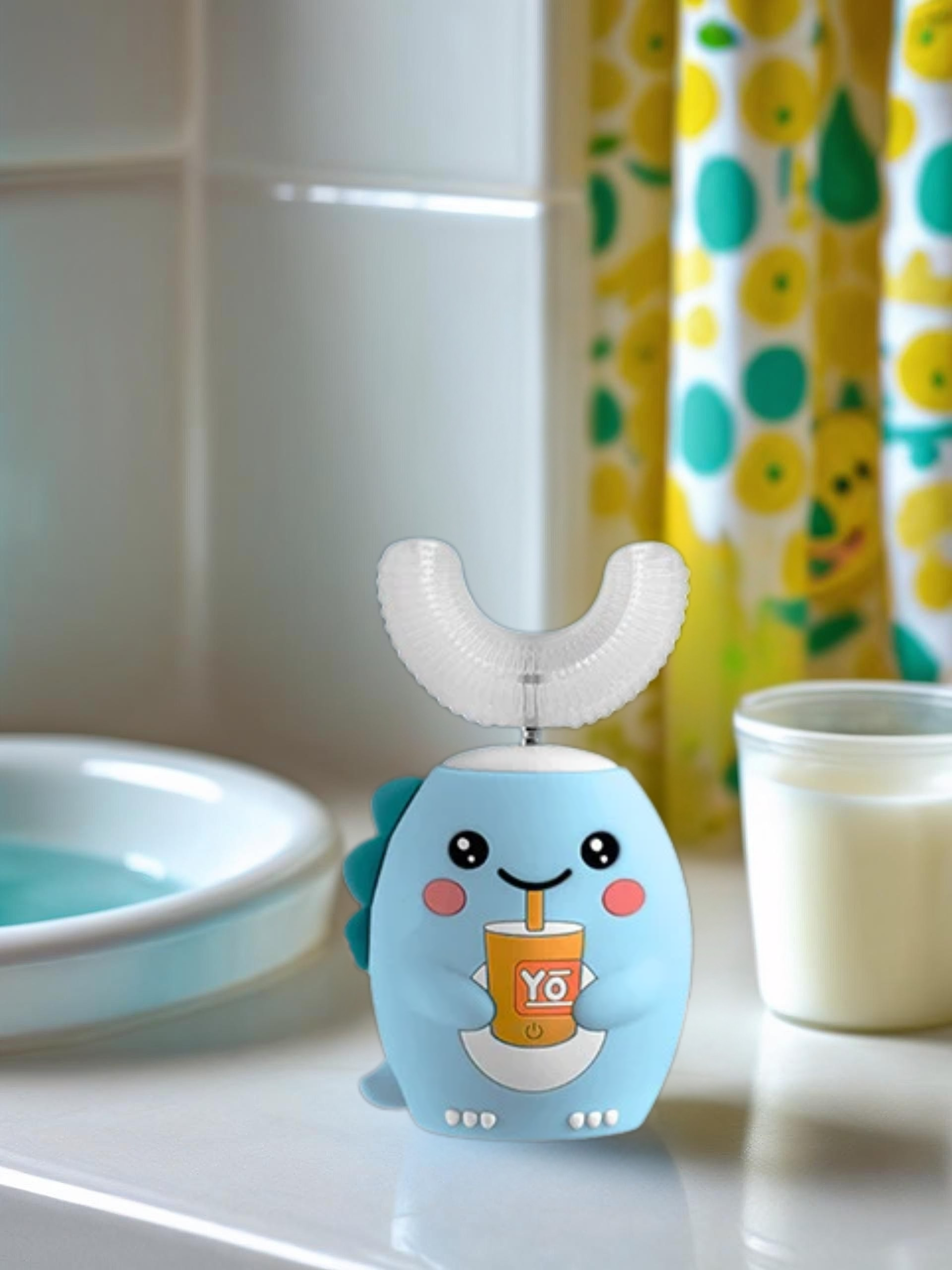 Cute cartoon-patterned toothbrush on a bathroom counter with a colorful shower curtain in the background.