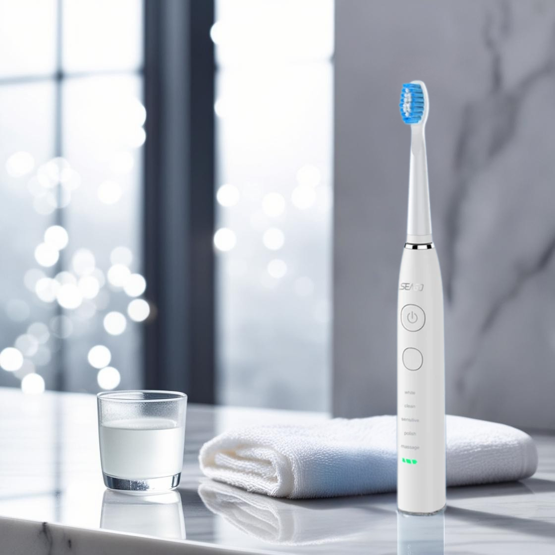 White electric toothbrush on a marble surface with a glass of water and towel in the background