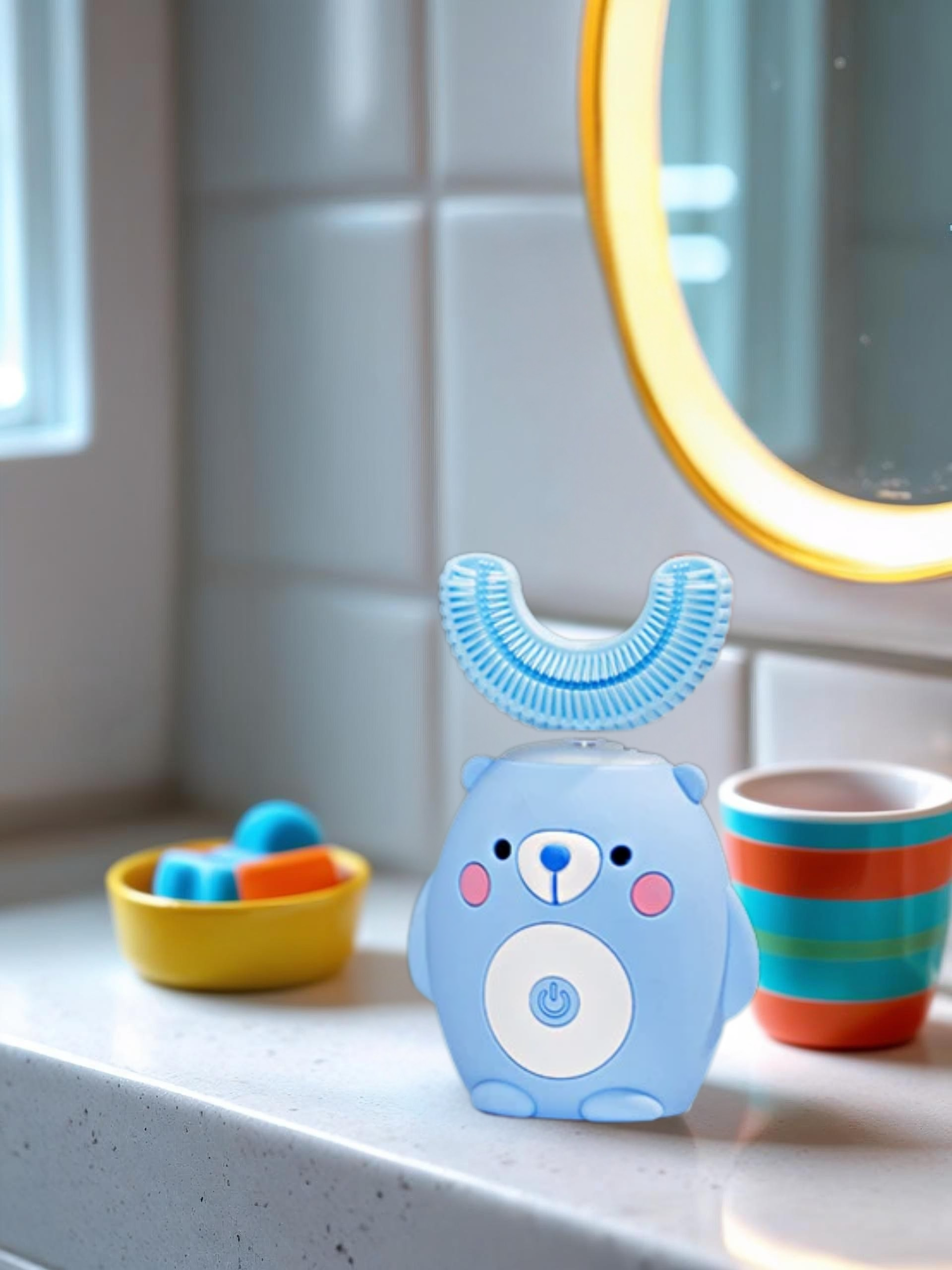 Children's blue toothbrush with bear design on a bathroom counter